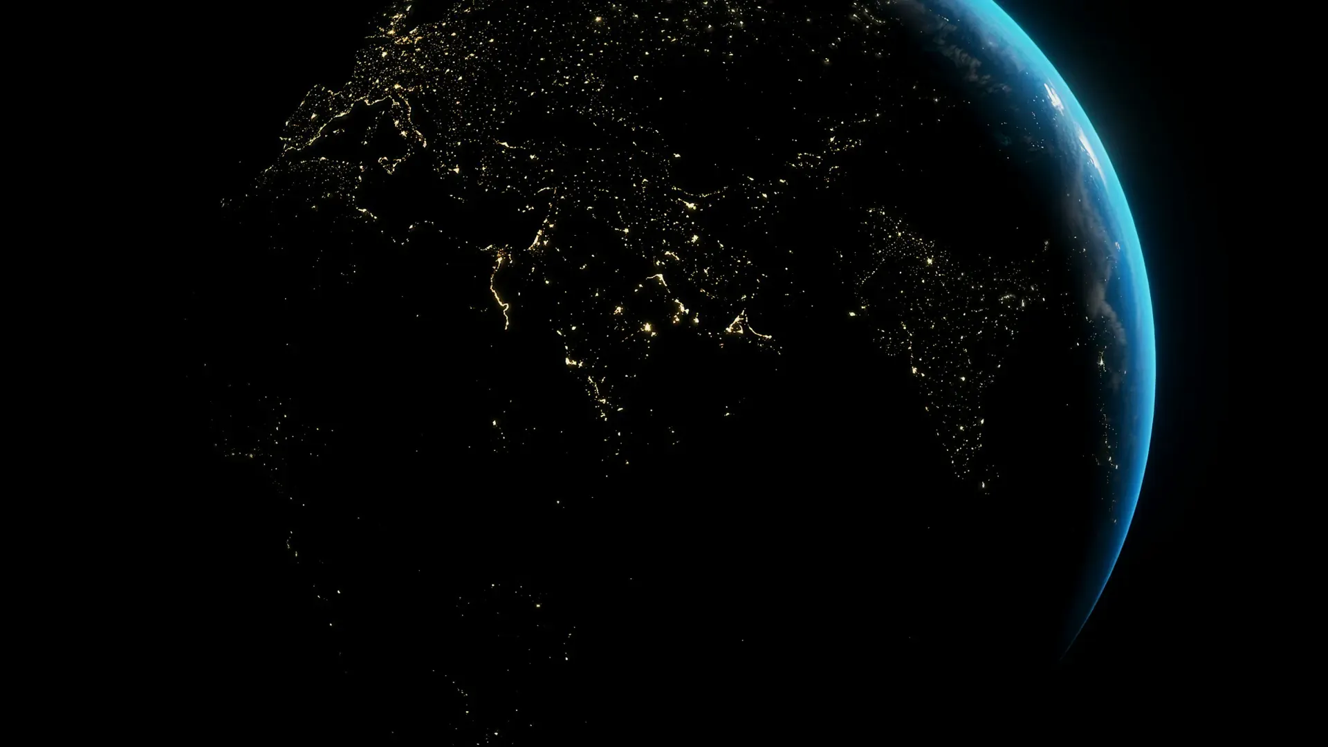 Planet Earth seen from space at night with city lights glowing against a black background